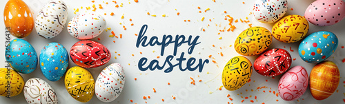 Colourful painted eggs lying on the white surface. Easter concept. Gift card with text.