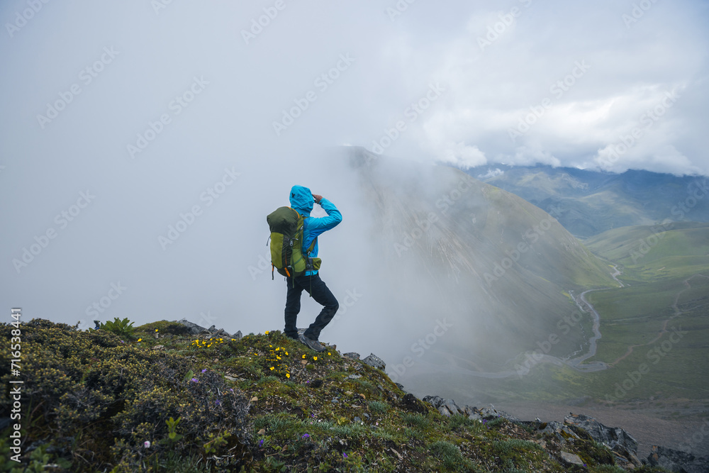 Woman hiker hiking on mountain top