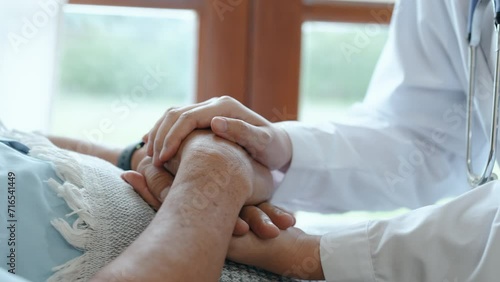 Female nurse doctor wear white uniform hold hand of senior grandmother patient help express empathy encourage tell diagnosis at medical visit photo