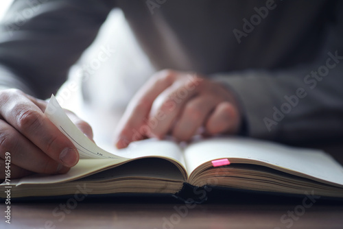 Read book. A man sits and reads literature. Textbooks to study. Religion. photo