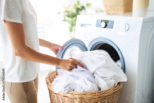 Woman using washing machine, Laundry concept