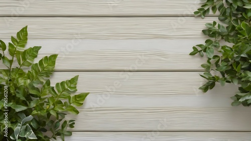 Top view on green leaves on a light white wooden background with copy space. Background for a postcard or presentation of a natural product