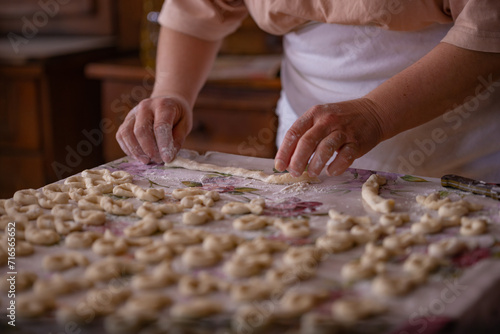 Cook's hands kneading dough for cakes. Preparing the flour for leavening