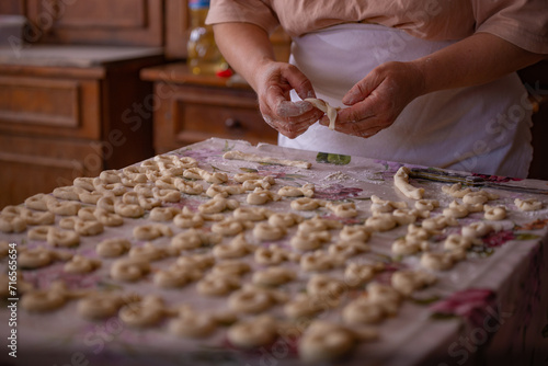 Cook's hands kneading dough for cakes. Preparing the flour for leavening