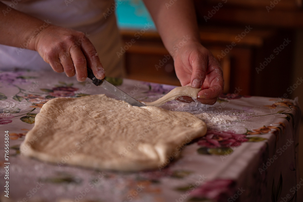 Cook's hands kneading dough for cakes. Preparing the flour for leavening Cook's hands kneading dough for cakes. Preparing the flour for leavening