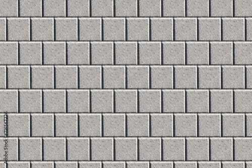 Gray brick pavement texture. Even blocks pattern. Brick flooring. Outdoor sunny texture. Walkway background. Brick pattern. Closeup construction. Square blocks.