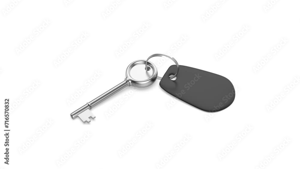 Silver old-fashioned key and blank black keyring on white background Silver old-fashioned key and blank black keyring on white background