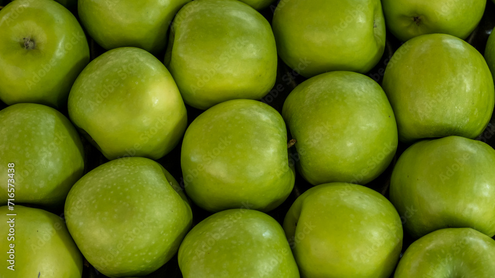close up of green apple arrangement in a modern market or supermarket close up of green apple arrangement in a modern market or supermarket