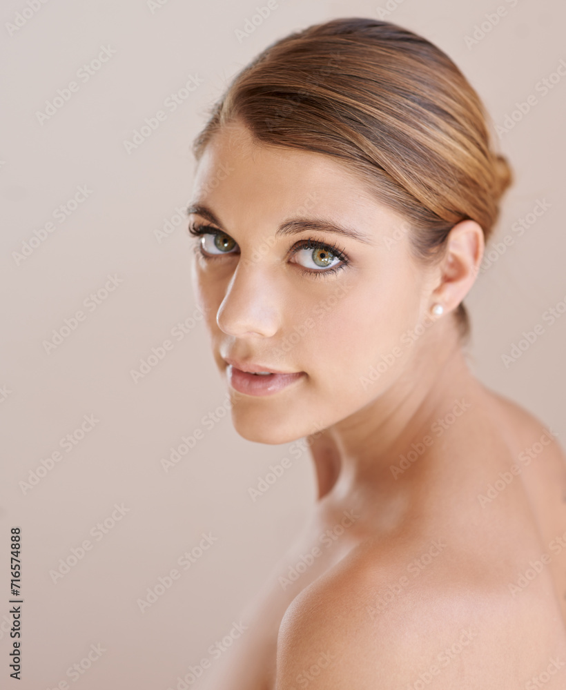 Portrait, natural beauty and skincare of woman in studio isolated on a brown background. Serious face, shoulder and young model in cosmetics, healthy skin glow or spa facial treatment for dermatology Portrait, natural beauty and skincare of woman in studio isolated on a brown background. Serious face, shoulder and young model in cosmetics, healthy skin glow or spa facial treatment for dermatology