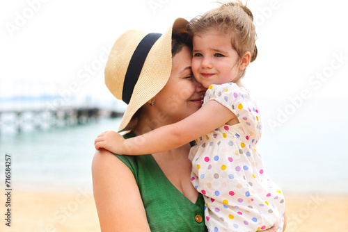 Mother and baby daughter at the beach