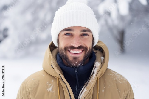 Man smiling with beautiful straight teeth, it's snowing on top, snowy background