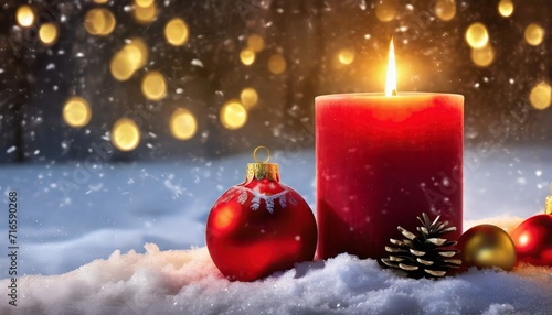 glowing red candle with christmas decoration in the snow