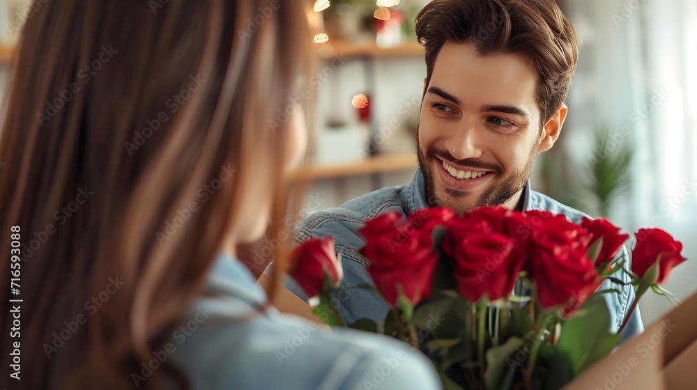 happy man giving bouquet of red roses to girlfriend happy man giving bouquet of red roses to girlfriend