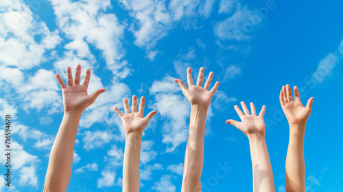 volunteering concept, hands of group of people in blue sky