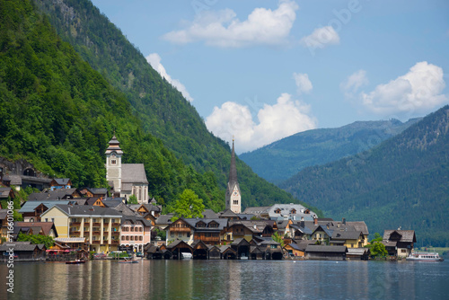 Hallstatt, a charming village on the Hallstattersee lake and a famous tourist attraction, with beautiful mountains surrounding it, in Salzkammergut region, Austria, in summer sunny day.