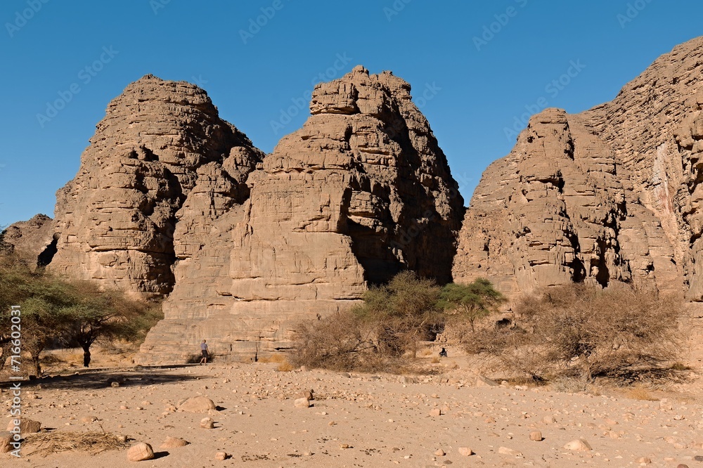 Rock formations at Guelta Tikoubaouine in the tourist area of Immourouden, near the town of Djanet. Tassili n Ajjer National Park. Sahara desert. Algeria. Africa.