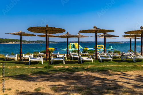 Deckchairs for rent and straw umbrellas on the beach