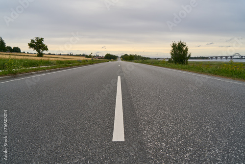 Asphalt street with two lanes and road markings in rural countryside