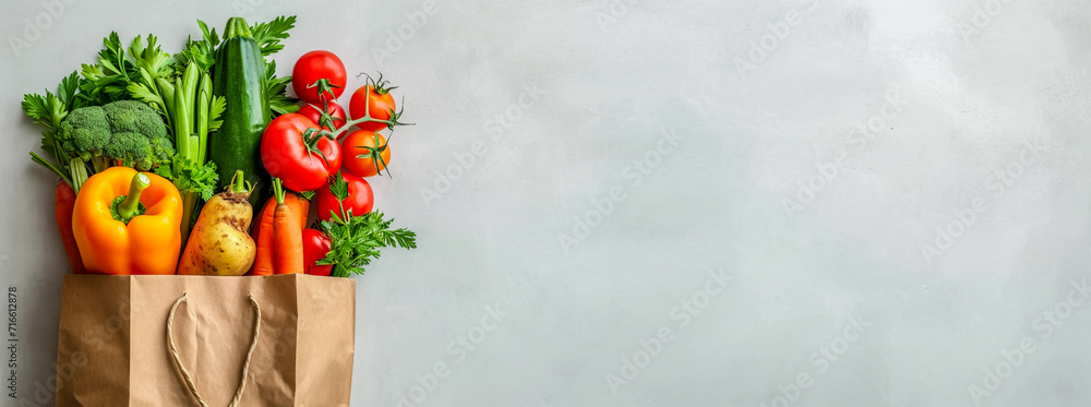 A grocery bag with various healthy vegetables, Tomatoes, cucumbers, sweet peppers, zucchini, cabbage, carrots, greens. The benefits of plant foods for proper nutrition. Copy space, banner - obrazy, fototapety, plakaty 