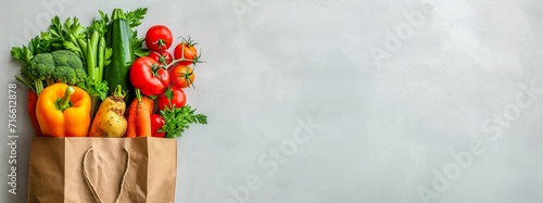 A grocery bag with various healthy vegetables, Tomatoes, cucumbers, sweet peppers, zucchini, cabbage, carrots, greens. The benefits of plant foods for proper nutrition. Copy space, banner