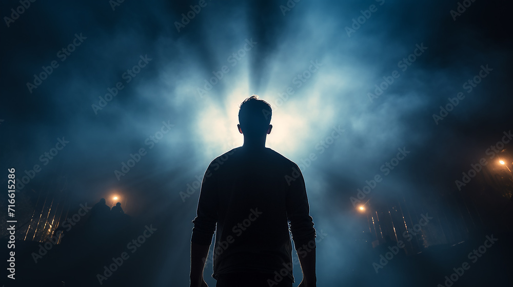 silhouette of a guy, a man view from the back against a background of blue fog and rays of light, a fictional character computer graphics
