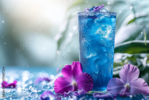 Blue lagoon cocktail with flowers  blue background.