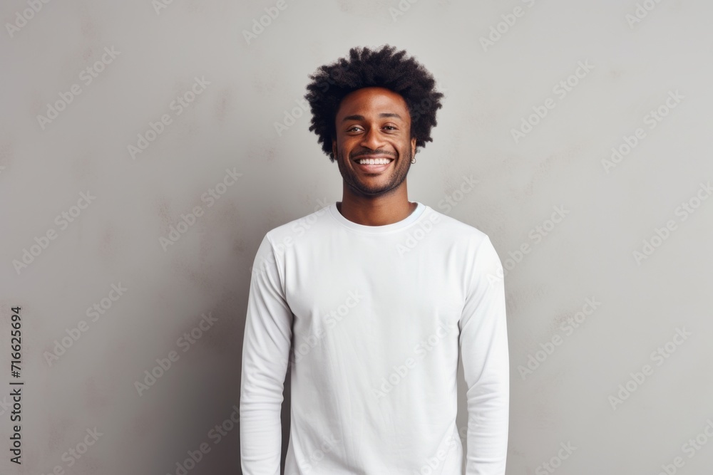 Obraz premium Portrait of a jovial afro-american man in his 30s sporting a long-sleeved thermal undershirt against a modern minimalist interior. AI Generation