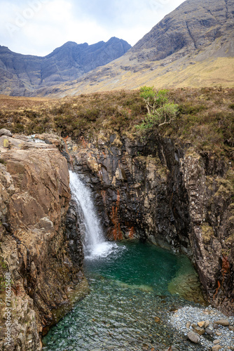 Mystical Cascade: A Waterfall in Fairy Pools Amidst Majestic Mountains