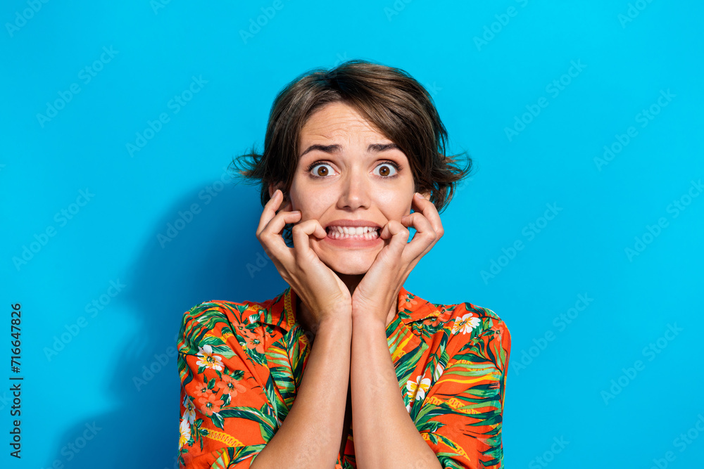 Fototapeta premium Photo of terrified embarrassed girl wear trendy clothes biting fingers celebrating halloween horror fear isolated on blue color background