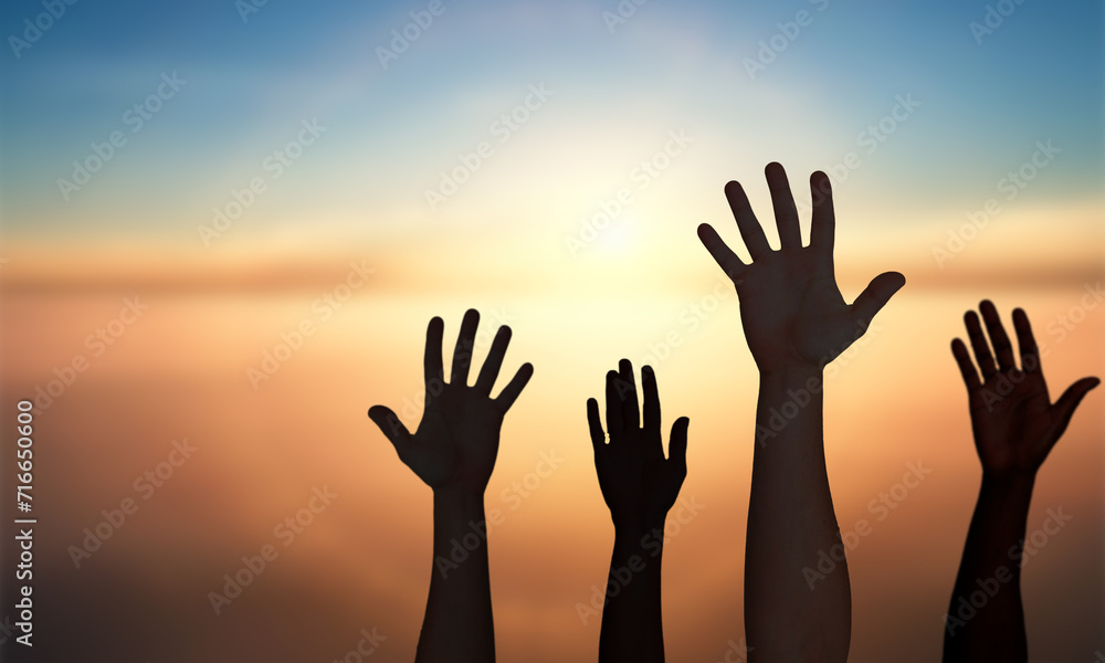 Group Of hands Silhouette Raised Against Sunset sky. Liberty, Togetherness and Volunteers People concept 