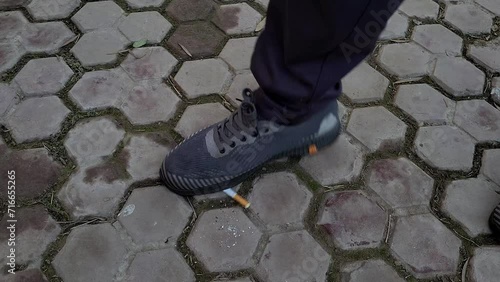 Man destroying cigarette  by its shoes, No smoking concept