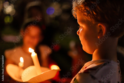 boy holding a real candle at carols by candlelight