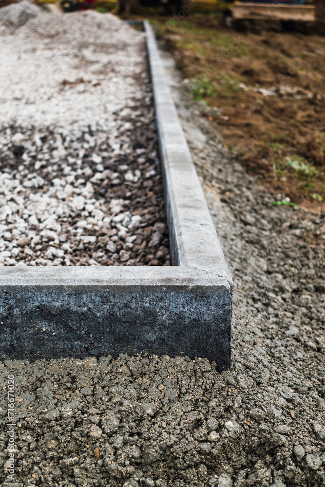 Concrete garden borders with cement to demarcate paths, parkings, sidewalks and flowerbeds Concrete garden borders with cement to demarcate paths, parkings, sidewalks and flowerbeds