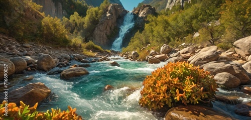  a river running through a lush green forest next to a forest covered with rocks and a lush green forest filled with lots of orange and yellow flowers next to a waterfall.