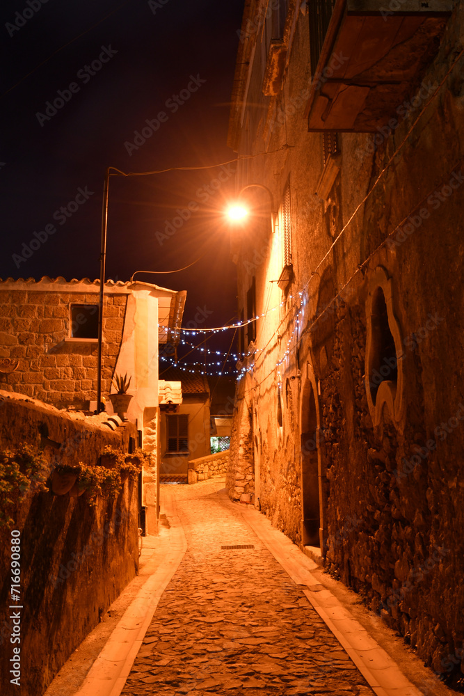 A narrow street among the old houses of a town in the Campania region in the province of Benevento, Italy.