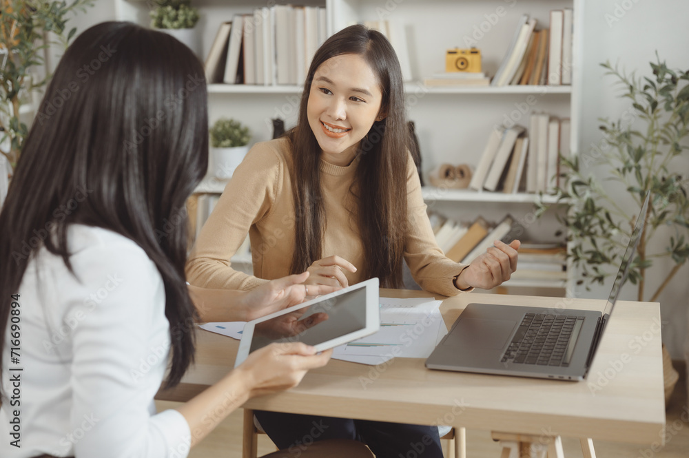 Business women are discussing work and analyzing investment data. Financial accounting and tax system concepts Business women are discussing work and analyzing investment data. Financial accounting and tax system concepts