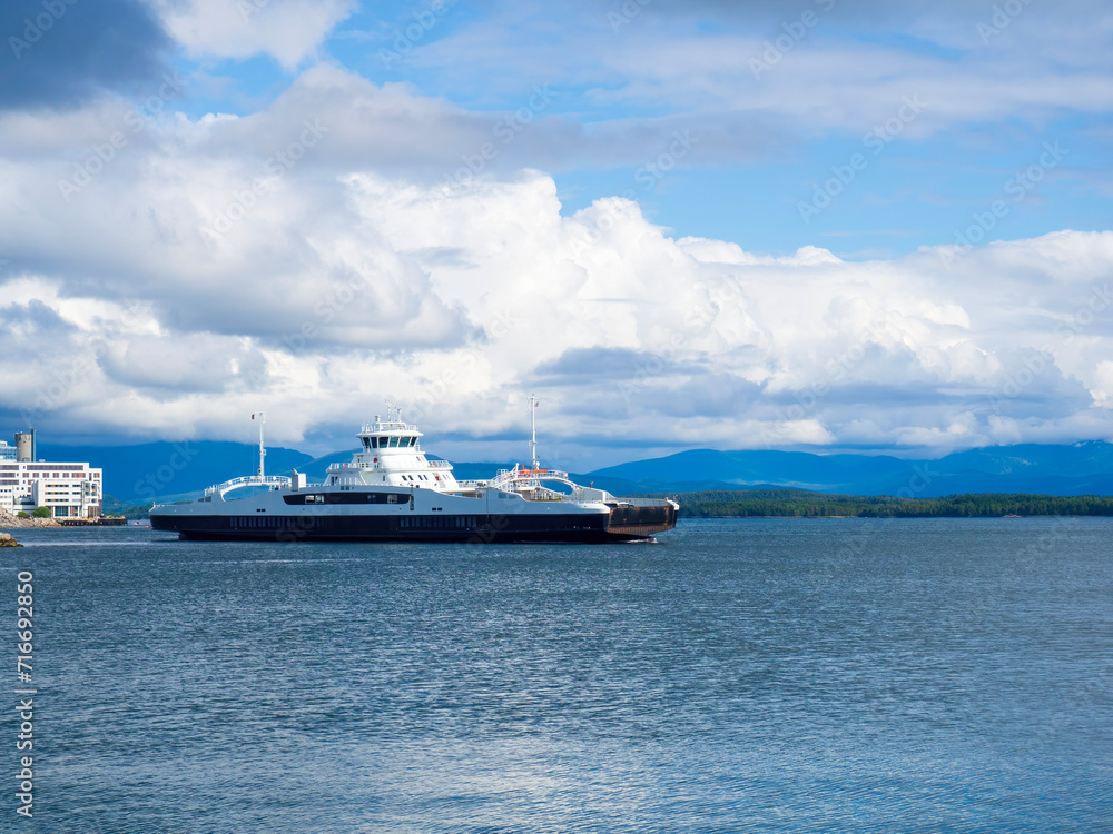 Ferry leaving Molde carrying vehicles and passengers over the fjord
