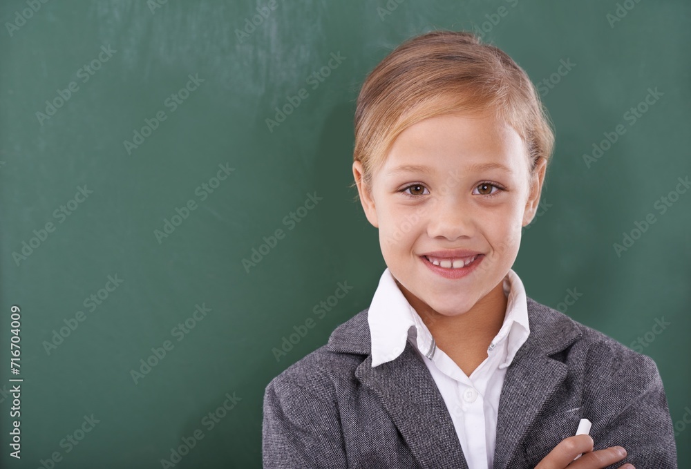 Child, portrait and chalkboard for school education in classroom for learning, writing or homework. Female person, uniform and kindergarten development or brainstorming or knowledge, study or mockup Child, portrait and chalkboard for school education in classroom for learning, writing or homework. Female person, uniform and kindergarten development or brainstorming or knowledge, study or mockup