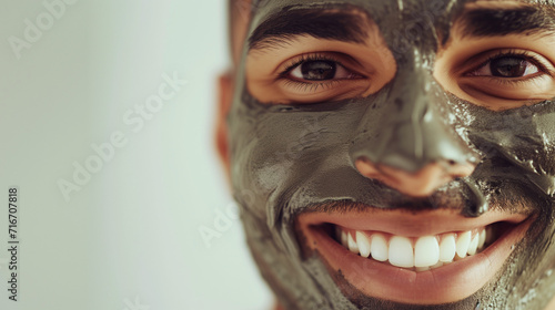 Mixed race man wearing a mud clay face mask, male skincare pampering routine, ai generated © Sophie 