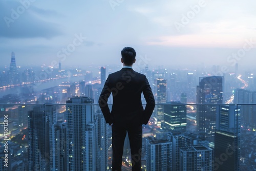 A businessman looking at a large city from the top of a skyscraper, contemplating