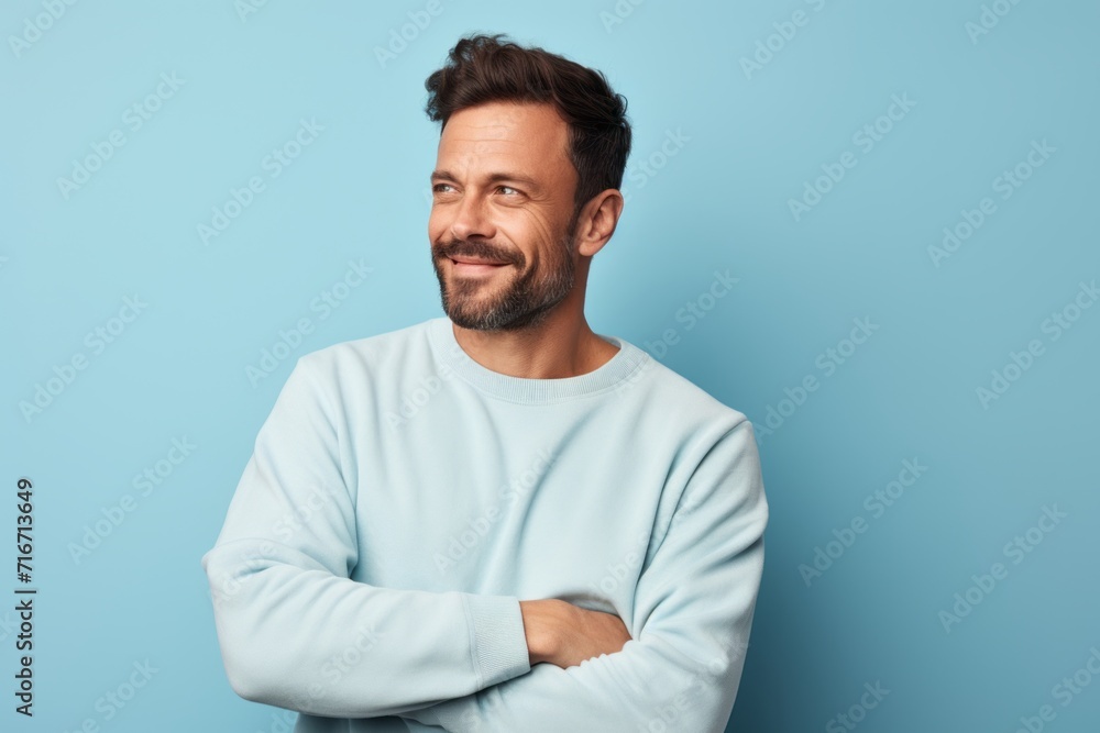 Portrait of a content man in his 30s dressed in a comfy fleece pullover against a pastel blue background. AI Generation Portrait of a content man in his 30s dressed in a comfy fleece pullover against a pastel blue background. AI Generation