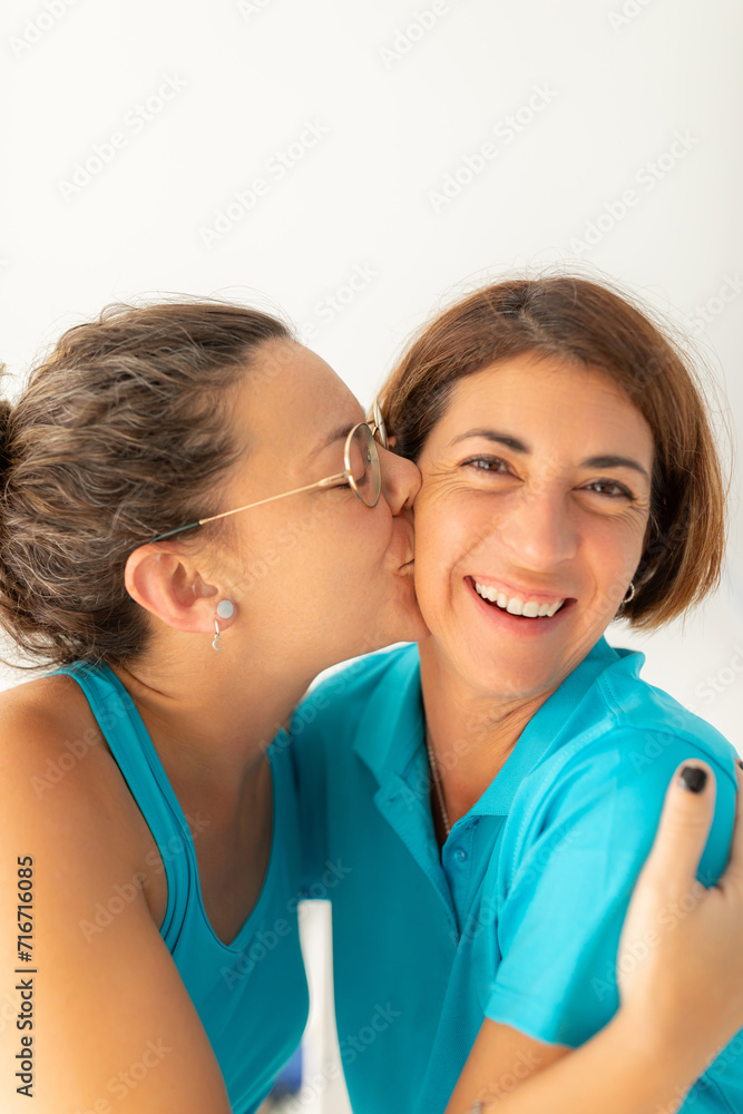 A woman gives a kiss to her physiotherapist friend, after receiving a massage at the physiotherapy clinic A woman gives a kiss to her physiotherapist friend, after receiving a massage at the physiotherapy clinic