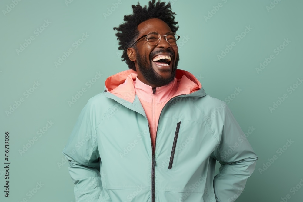 Portrait of a joyful afro-american man in his 40s wearing a functional windbreaker against a pastel gray background. AI Generation Portrait of a joyful afro-american man in his 40s wearing a functional windbreaker against a pastel gray background. AI Generation