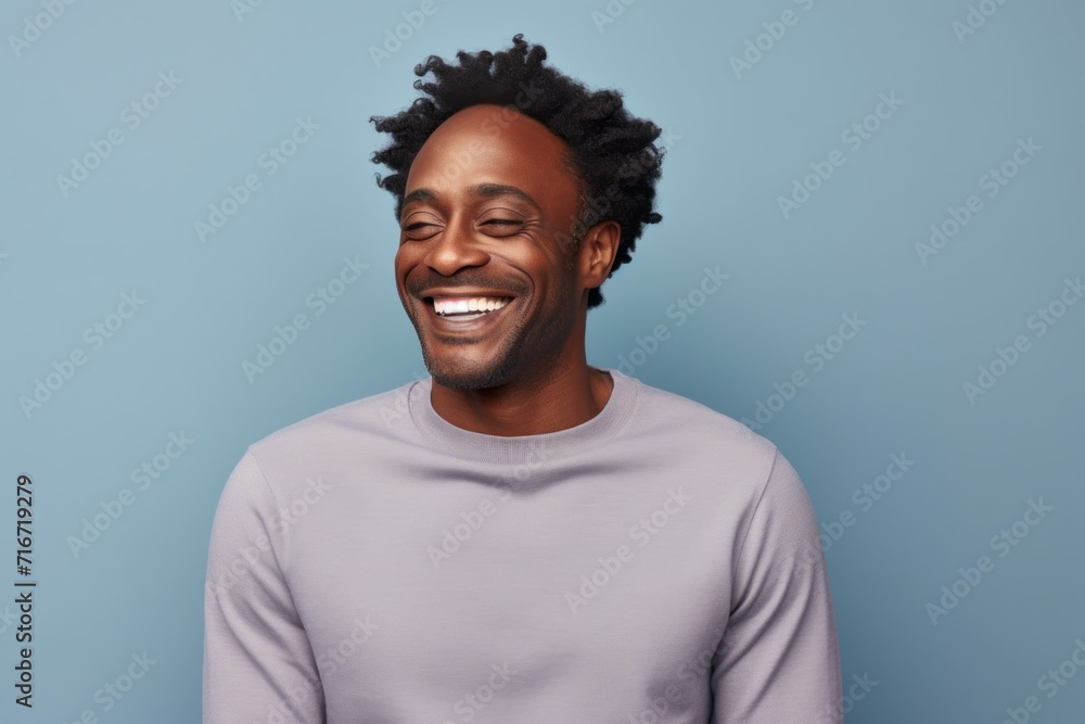 Portrait of a grinning afro-american man in his 40s showing off a thermal merino wool top against a pastel gray background. AI Generation Portrait of a grinning afro-american man in his 40s showing off a thermal merino wool top against a pastel gray background. AI Generation