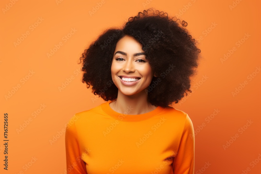 Portrait of a cheerful afro-american woman in her 30s showing off a thermal merino wool top against a soft orange background. AI Generation Portrait of a cheerful afro-american woman in her 30s showing off a thermal merino wool top against a soft orange background. AI Generation