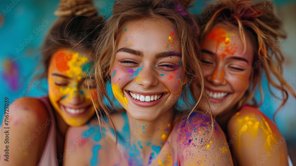 A group of friends hugging and laughing during the Holi holiday A group of friends hugging and laughing during the Holi holiday
