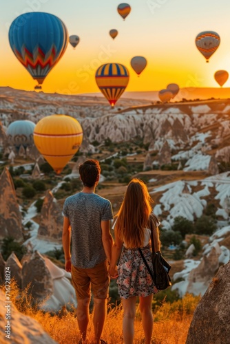 Couple in love with hot air balloons in Cappadocia, Turkey