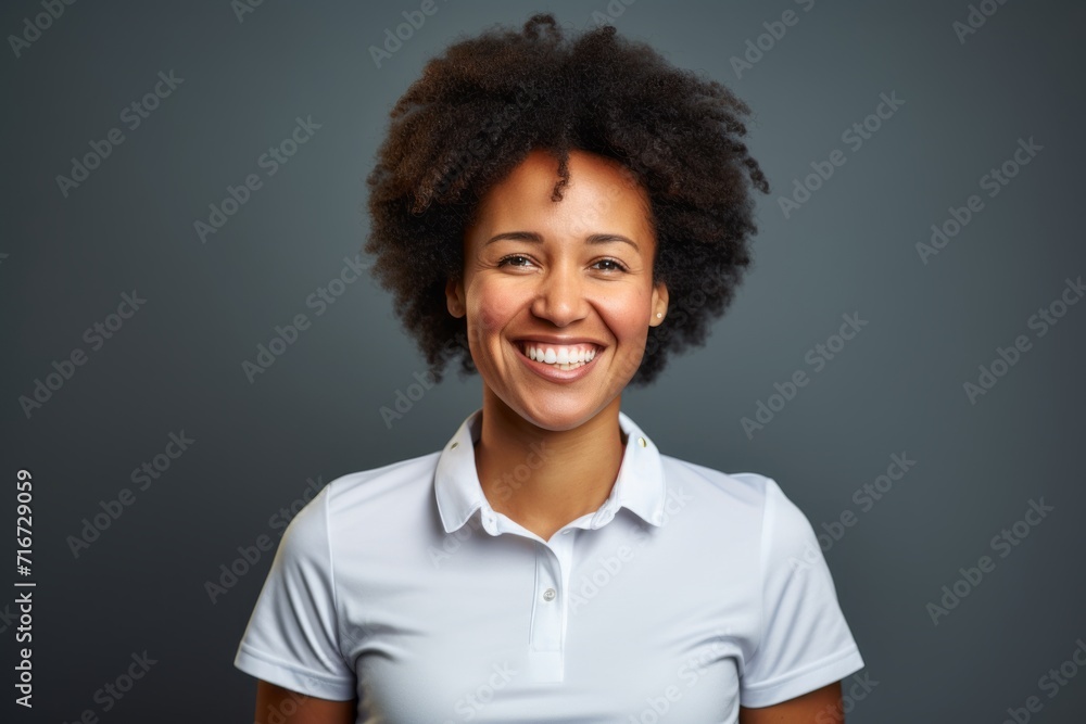 Portrait of a happy afro-american woman in her 30s wearing a sporty polo shirt against a soft gray background. AI Generation Portrait of a happy afro-american woman in her 30s wearing a sporty polo shirt against a soft gray background. AI Generation