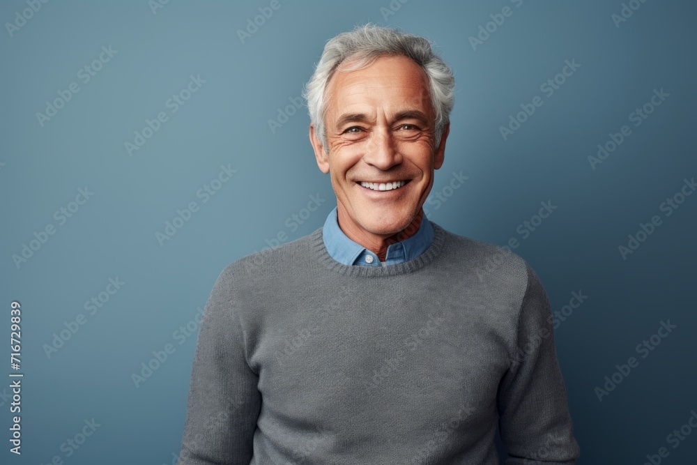 Portrait of a happy man in his 70s showing off a thermal merino wool top against a soft gray background. AI Generation Portrait of a happy man in his 70s showing off a thermal merino wool top against a soft gray background. AI Generation