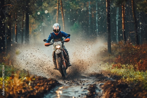 Motocross rider on a muddy road in the forest during rain. Motocross. Enduro. Extreme sport concept.